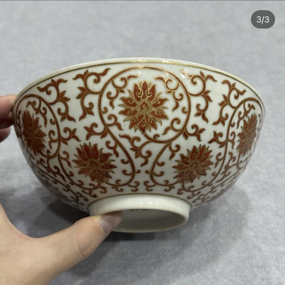 Piece B: iron-red lotus scroll bowl held in the hand